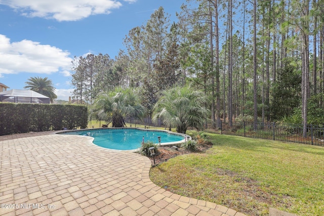 view of swimming pool with a yard and a patio area