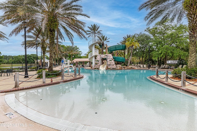 view of swimming pool with a water slide