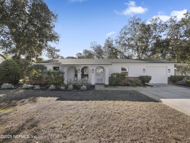 ranch-style house with a porch and a garage