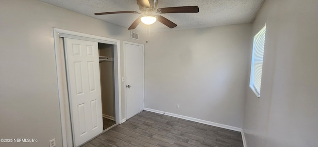 unfurnished bedroom featuring a textured ceiling, ceiling fan, and a closet