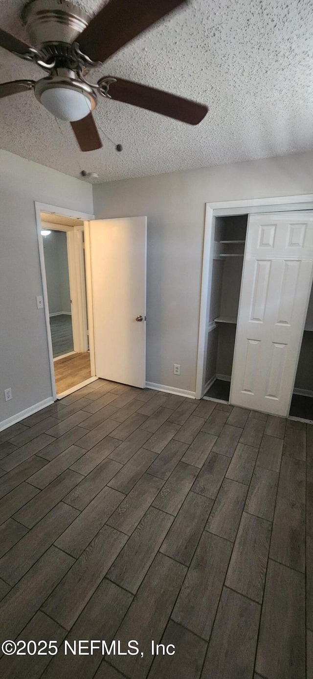 unfurnished bedroom with ceiling fan, a closet, and a textured ceiling