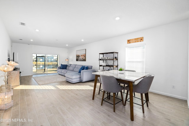 dining area featuring light wood-type flooring