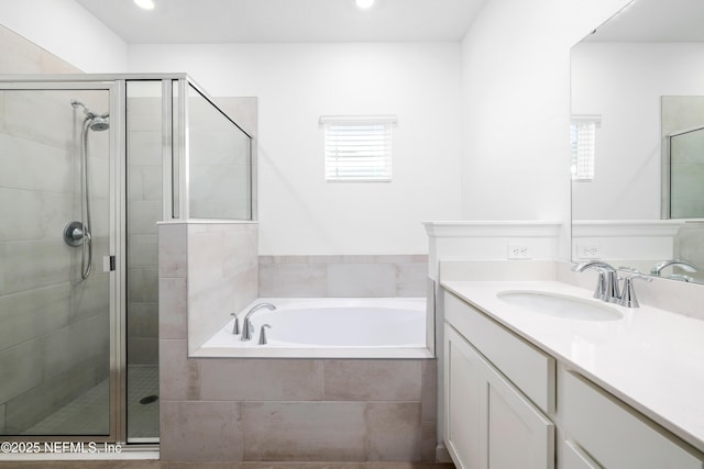 bathroom with vanity and independent shower and bath