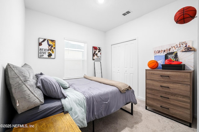 bedroom featuring light carpet and a closet