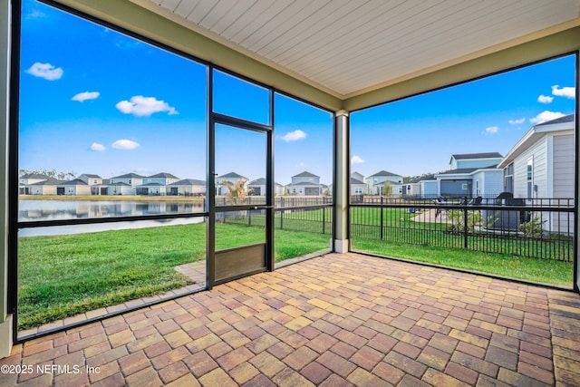 unfurnished sunroom with a water view