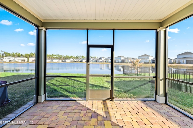 unfurnished sunroom with a water view and wood ceiling