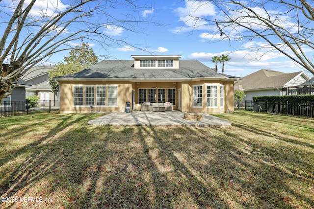 rear view of house featuring a lawn and a patio