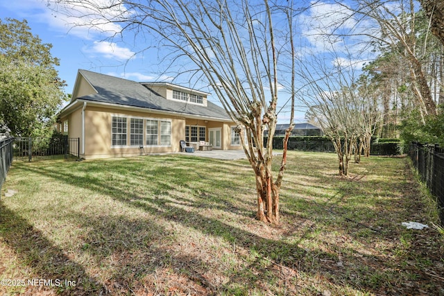 back of house featuring a yard and a patio