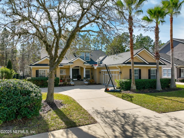 view of front of house featuring a garage and a front yard