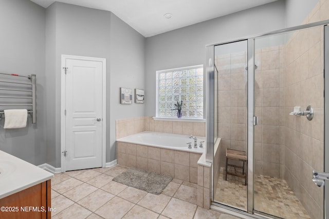 bathroom featuring vanity, radiator heating unit, tile patterned floors, and plus walk in shower