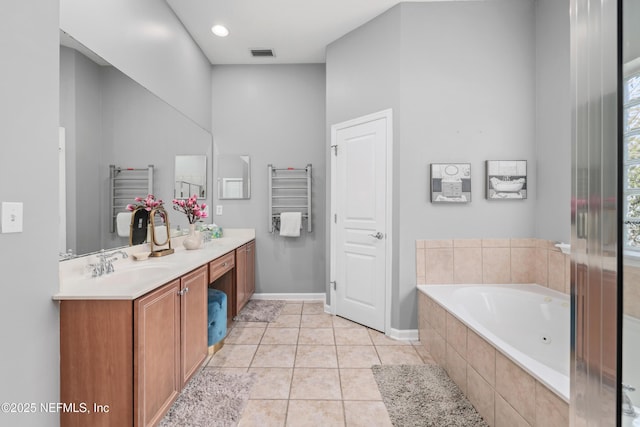 bathroom with a relaxing tiled tub, tile patterned floors, vanity, and radiator