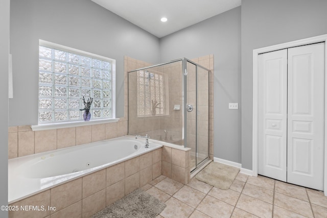 bathroom featuring tile patterned flooring and separate shower and tub