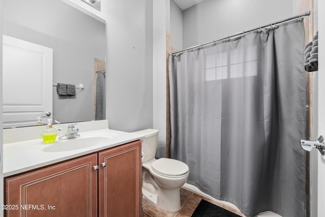 bathroom featuring walk in shower, tile patterned floors, vanity, and toilet