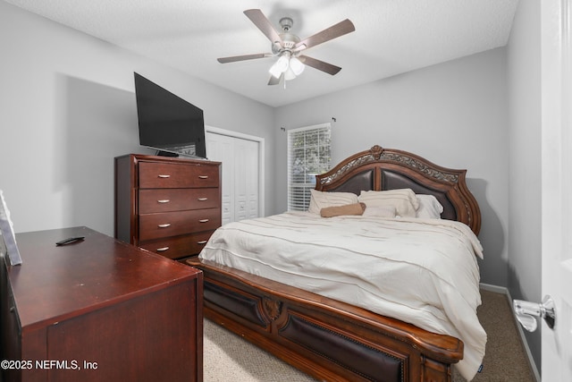 carpeted bedroom with ceiling fan and a closet