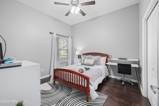 bedroom featuring dark hardwood / wood-style flooring, lofted ceiling, ceiling fan, and a closet