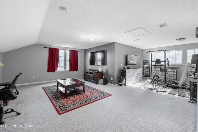 carpeted office featuring lofted ceiling and a textured ceiling