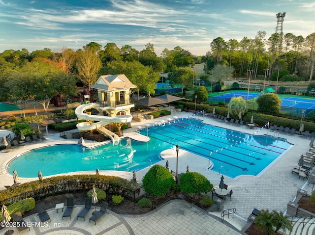 view of pool featuring a patio and a water slide