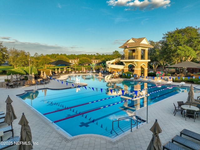 view of swimming pool featuring a patio and a water slide