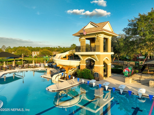 view of pool with a patio and a water slide