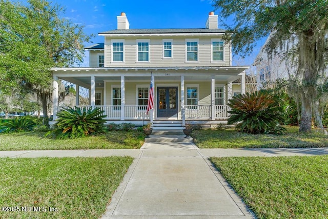 view of front of home with french doors and a front yard