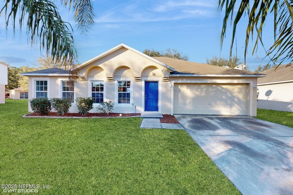 ranch-style house featuring a garage and a front yard