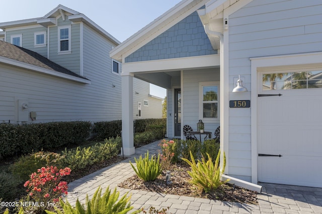 entrance to property with a garage and a porch