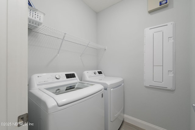 clothes washing area with washing machine and clothes dryer