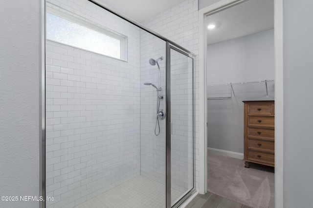 bathroom featuring a shower with door and hardwood / wood-style flooring