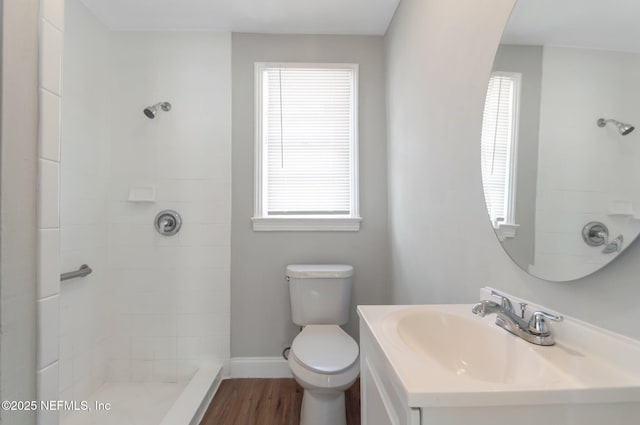 bathroom with hardwood / wood-style flooring, vanity, plenty of natural light, and toilet