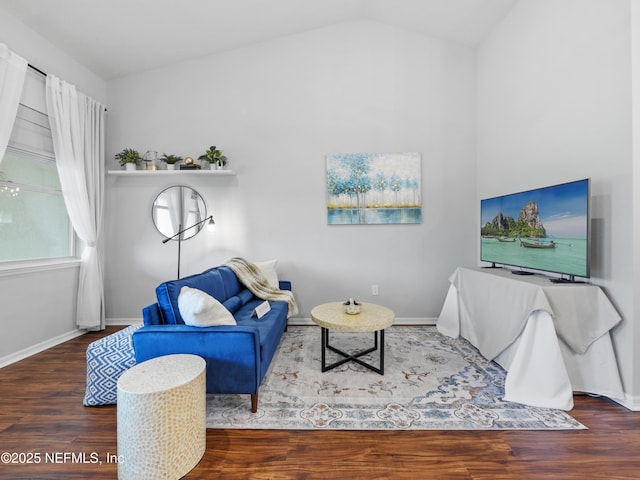 living room featuring dark wood-type flooring and vaulted ceiling