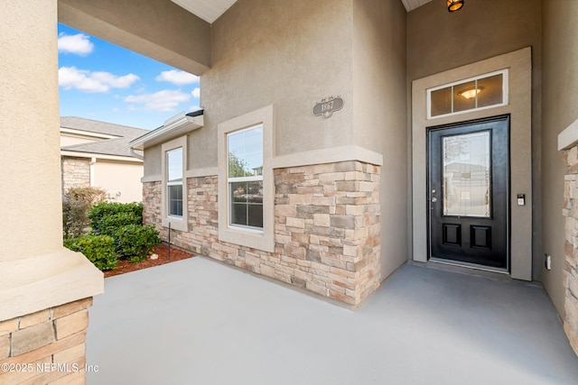 doorway to property featuring a patio area