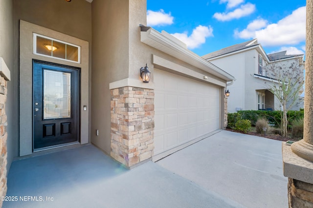 view of exterior entry with a garage