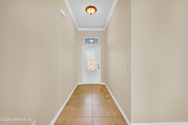 entryway with light tile patterned floors and crown molding