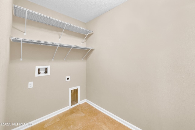 laundry room with electric dryer hookup, hookup for a washing machine, and a textured ceiling