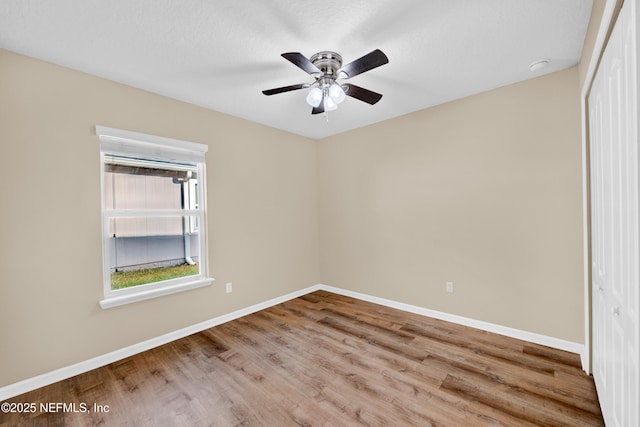 spare room featuring ceiling fan and wood-type flooring