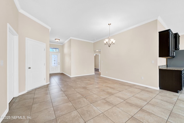 tiled spare room with ornamental molding and an inviting chandelier