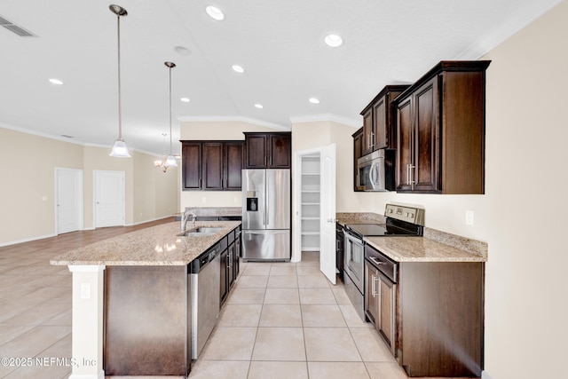 kitchen featuring sink, dark brown cabinetry, hanging light fixtures, light stone countertops, and stainless steel appliances