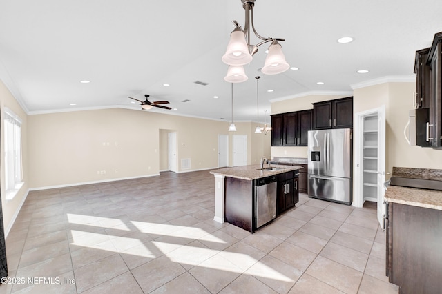 kitchen with ceiling fan with notable chandelier, pendant lighting, lofted ceiling, stainless steel appliances, and a center island with sink