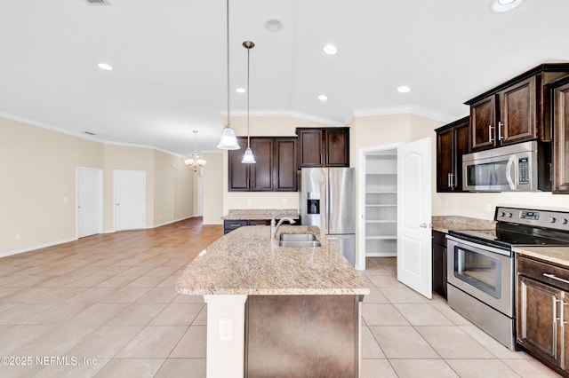 kitchen with pendant lighting, sink, appliances with stainless steel finishes, an island with sink, and ornamental molding