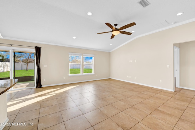 empty room with lofted ceiling, ceiling fan, light tile patterned flooring, and crown molding