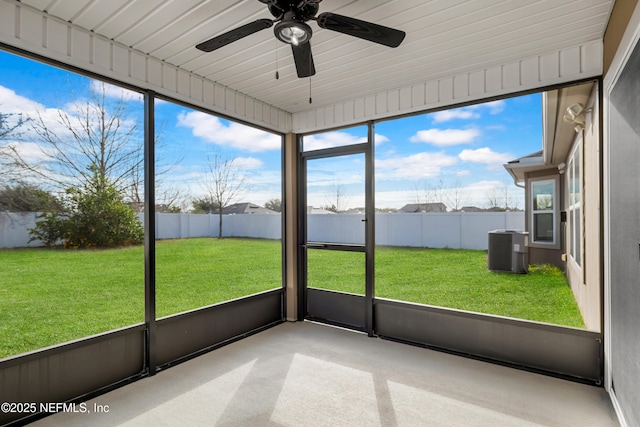 unfurnished sunroom featuring ceiling fan and a healthy amount of sunlight