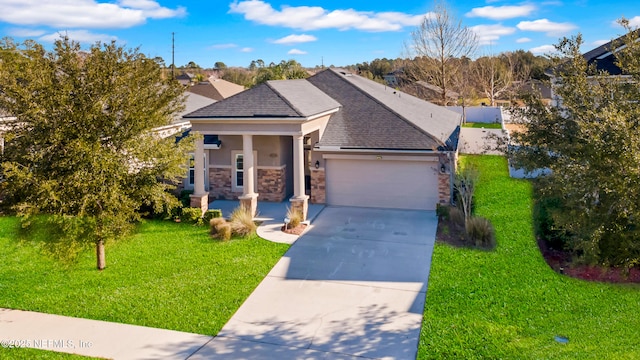 view of front facade featuring a front lawn, a garage, and a porch