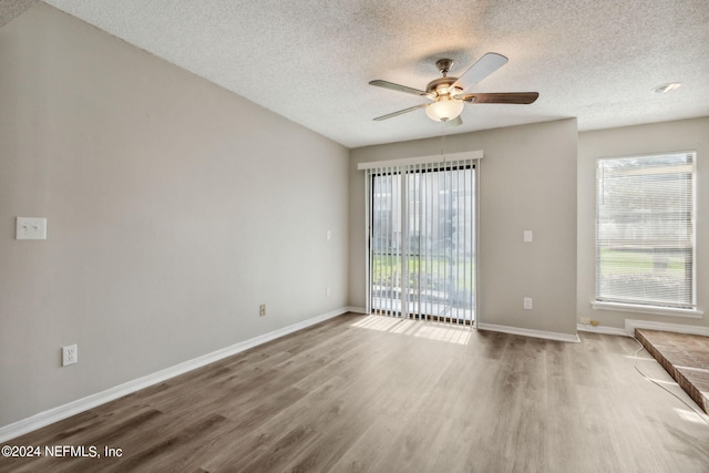 unfurnished room with wood-type flooring, a textured ceiling, and ceiling fan