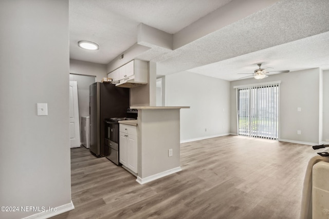 kitchen featuring electric range, ceiling fan, a textured ceiling, light hardwood / wood-style flooring, and white cabinetry