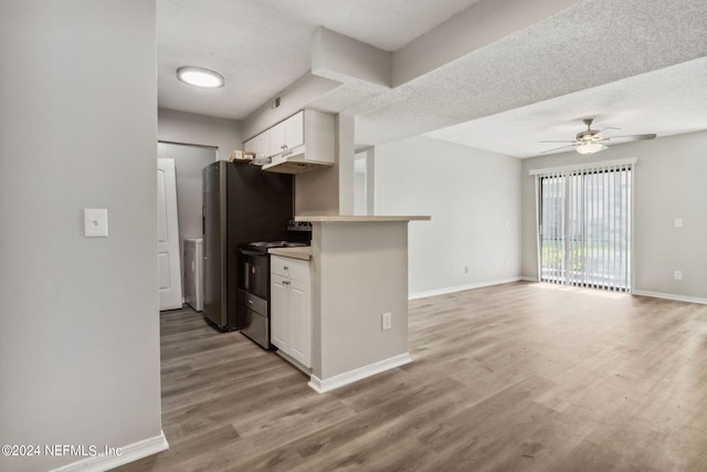 kitchen with white cabinets, a textured ceiling, ceiling fan, stainless steel electric range oven, and light hardwood / wood-style flooring