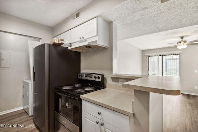 kitchen with white cabinets, range with electric cooktop, a textured ceiling, and kitchen peninsula