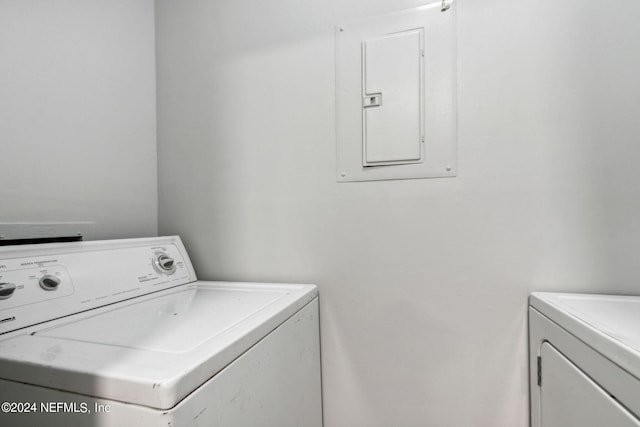 washroom featuring electric panel and washing machine and dryer