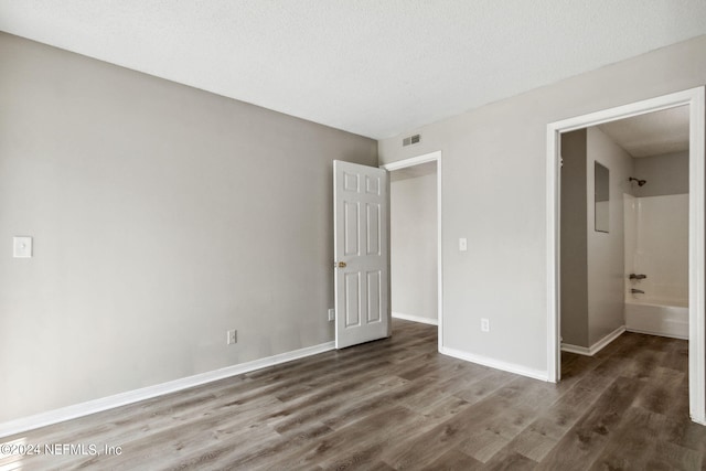 unfurnished bedroom featuring dark wood-type flooring