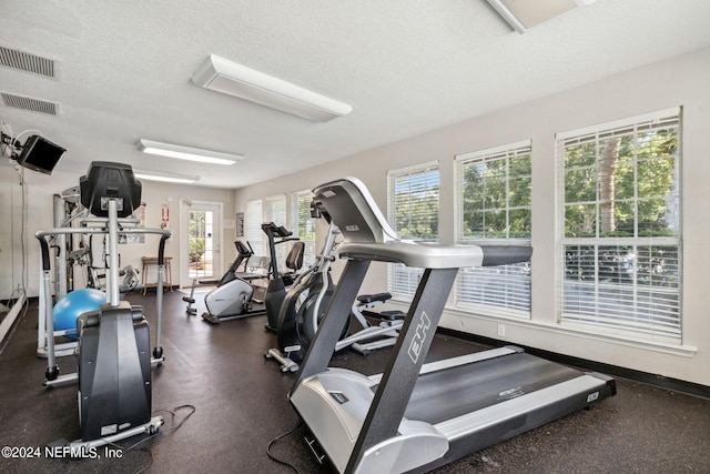 gym featuring a textured ceiling