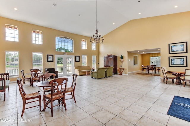 tiled dining space with a high ceiling and a chandelier